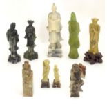 A quantity of assorted Oriental soapstone carvings to include a figural hand seal, model of Guan
