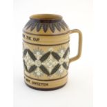 A Doulton Lambeth stoneware verse tankard, with relief foliate detail and the motto Bitter Must Be