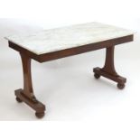 A mid 19thC mahogany marble top table by Gillows. Having a marble top above three short drawers with
