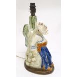 A mid 20thC figural ceramic table lamp by Jersey Pottery, formed as a Caballero with guitar