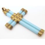 A pendant of cross form set with gilt metal mounts and turquoise colour detail. Approx. 3 1/4"