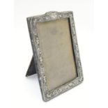 An easel back photograph frame with silver surround, hallmarked Birmingham 1903, maker Henry