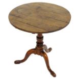 A late 18thC yew wood tripod table with a circular top above a turned pedestal base and three