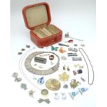 A jewellery box containing assorted jewellery badges, pins, brooches, necklaces etc Please Note - we