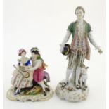 Two German porcelain figures, a model of a young man holding a hat and flower with a dog beside him,