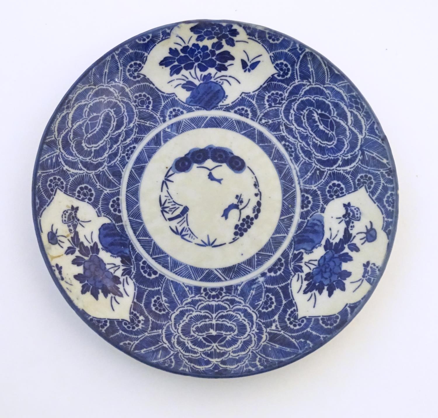 An Oriental blue and white plate with stylised peony detail, and stylised scrolling flower motifs to - Image 4 of 8