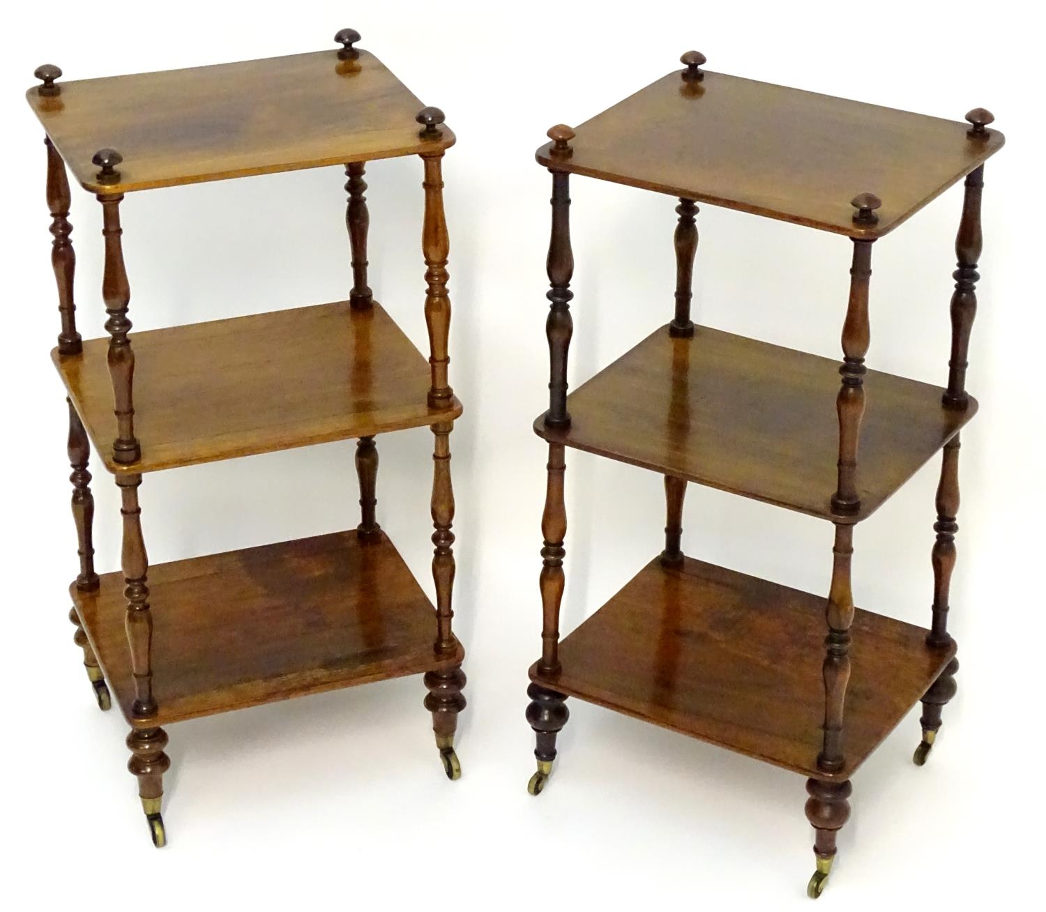 A pair of regency rosewood whatnots with turned finials to the tops and three tiers united by turned