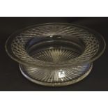 A large early 20thC lead crystal bowl, with a swept concave waist, decorated with a hobnail band and