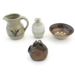 Four assorted studio pottery wares comprising a flask with relief roundel and laced detail by Tremar