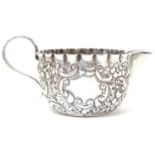 A Victorian silver cream jug with embossed acanthus and foliate scroll detail, hallmarked 1888,