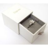 A Welsh silver Clogau ring with central diamond set in Welsh rose gold in flower design marked