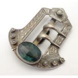 An Arts & Crafts white metal buckle set with pearls and facet cut green stone. Possibly Scottish.