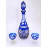 An early 20thC blue glass decanter, decorated with hobnail and starburst cuts, together two