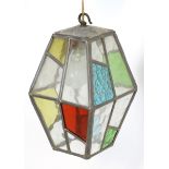 An early 20thC pendant lamp shade / lantern with stained and clear glass panels within lead