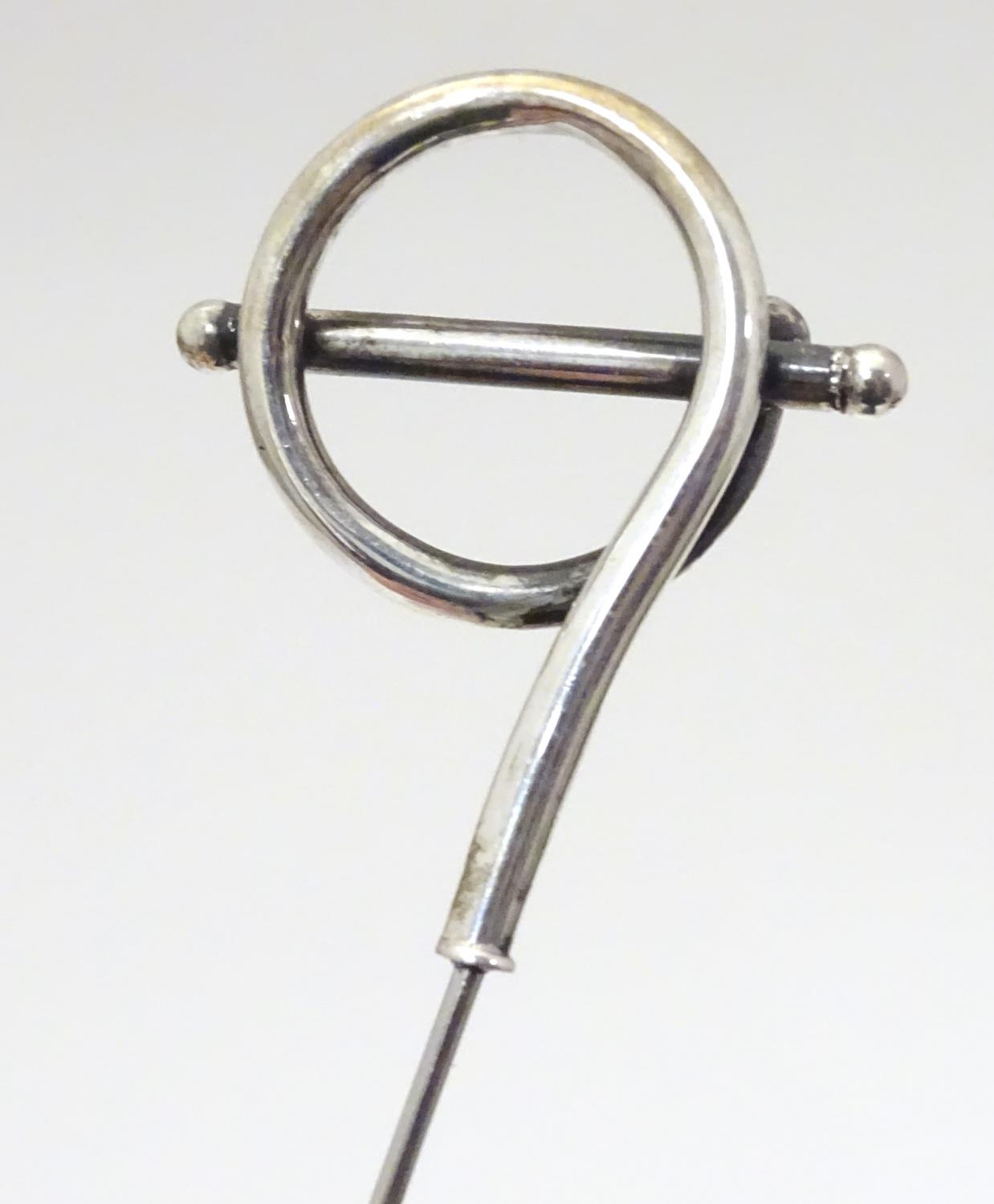 A silver hat pin with scroll decoration hallmarked 1908, maker G. E. Walton & Co. Ltd. Approx. 9 1/