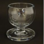 A 19thC pedestal glass with heavy broad circular foot, possibly a tavern salt. 4 1/" high 4" wide