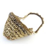 Ethnographic / Native / Tribal: A woven basket with cowrie shell detail and loop handle. Basket