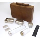 A small leather attaché case / vanity case with associated silver plate bottles etc Please Note - we