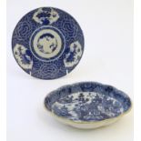 An Oriental blue and white plate with stylised peony detail, and stylised scrolling flower motifs to