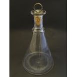 A glass decanter of conical form with silver plate mounted cork stopper. The whole approx. 13 1/2"