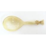 A 20thC horn caddy spoon with carved pineapple finial. Approx. 3 1/2" Please Note - we do not make