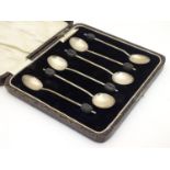 A cased set of six silver coffee spoons with coffee bean finials, hallmarked Birmingham 1928,