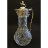 A Victorian claret jug, decorated with diamond and star cuts, the silver plated mount surmounted
