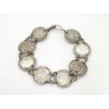 An early 20thC coin bracelet, linked by eight Edwardian 3d threepenny coins, 7" long Please Note -