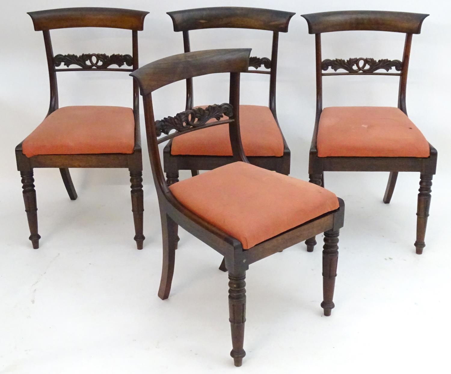 A set of four William IV rosewood dining chairs with shaped top rails, pierced mid rails, drop in