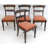 A set of four William IV rosewood dining chairs with shaped top rails, pierced mid rails, drop in