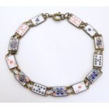 A vintage gilt metal bracelet, the links with enamel decoration depicting playing cards. Approx.