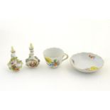 A pair of Continental vases with relief floral decoration. Together with a tea cup and saucer with