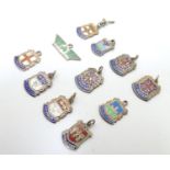 A quantity of assorted silver pendant charms with enamel decoration, souvenir charms to include