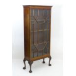 An early 20thC mahogany astragal glazed cabinet, having a moulded cornice above a single glazed door
