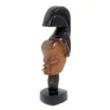 Ethnographic / Native / Tribal: A carved wooden head with stylised headdress. Approx. 11" high