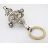 A silver rattle with embossed decoration and teething ring, hallmarked Birmingham 1919, maker