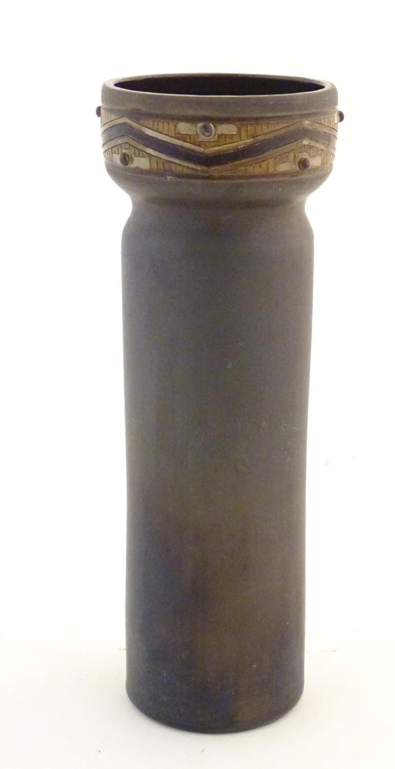 A tall studio pottery vase of cylindrical form with banded decoration to the rim. Incised mark