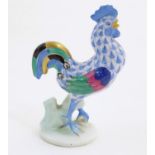 A Herend pottery model of a cockerel with fishnet decoration and gilt highlights. Marked under.