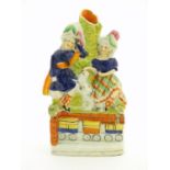 A Victorian Staffordshire pottery bud vase with two children in highland dress with a dog between