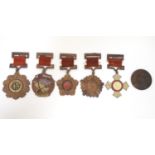 Militaria: a mid 20thC Chinese PLA medal group, comprising five copper medals and a badge (6) Please