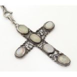 An Arts & Crafts white metal pendant of cross form set with five opalescent moonstone cabochon, with