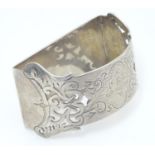 A silver napkin ring with engraved and pierced decoration Sheffield 1903 maker Walker & Hall