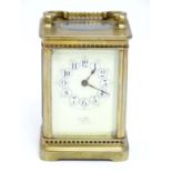 An early 20thC brass carriage clock with French movement and dial signed ' Henry Wells Formerly