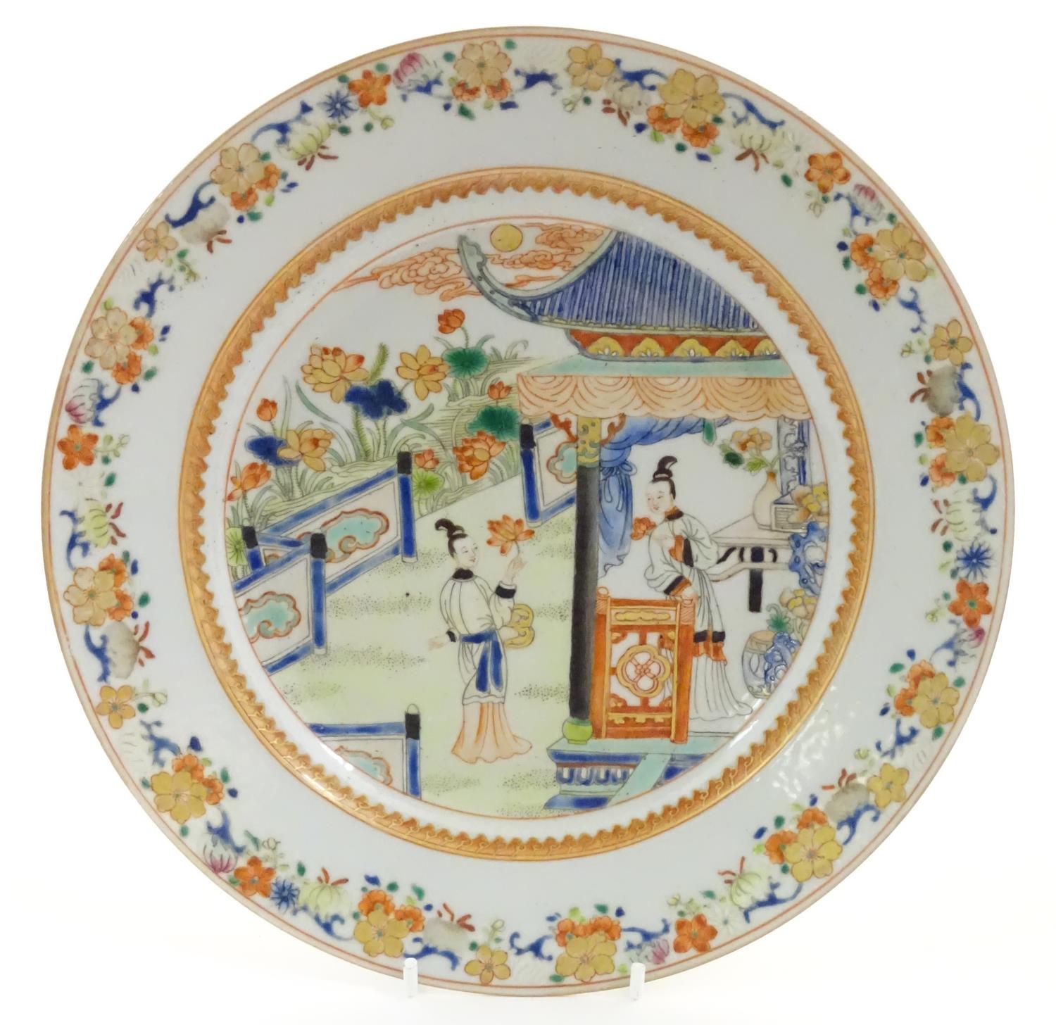 A Chinese plate depicting two ladies in a garden terrace with flowers, foliate, vases, etc. - Image 3 of 6