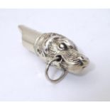 A silver whistle with dog head decoration 2" long Please Note - we do not make reference to the