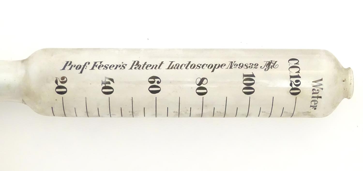 A 20thC cased glass Lactoscope with metal base, the interior with label: 'Professor Feser's Patent - Image 4 of 7