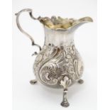 A Geo III silver cream jug London 1762 maker WC. 4" high Please Note - we do not make reference to