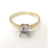 A 9ct gold ring set with cubic zirconia solitaire. Ring size approx K Please Note - we do not make