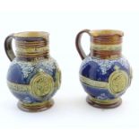 A pair of Doulton Lambeth Queen Victoria Diamond Jubilee stoneware commemorative jugs with relief