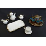 Toys: A ceramic doll's tea set, comprising coffee pot, teapot, sugar bowl, cream jug, cup, saucer